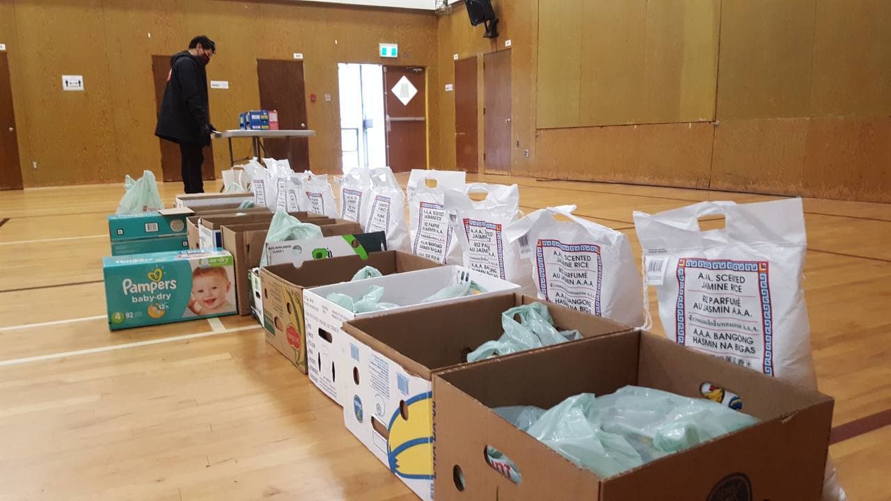 Volunteers organizing food on tables