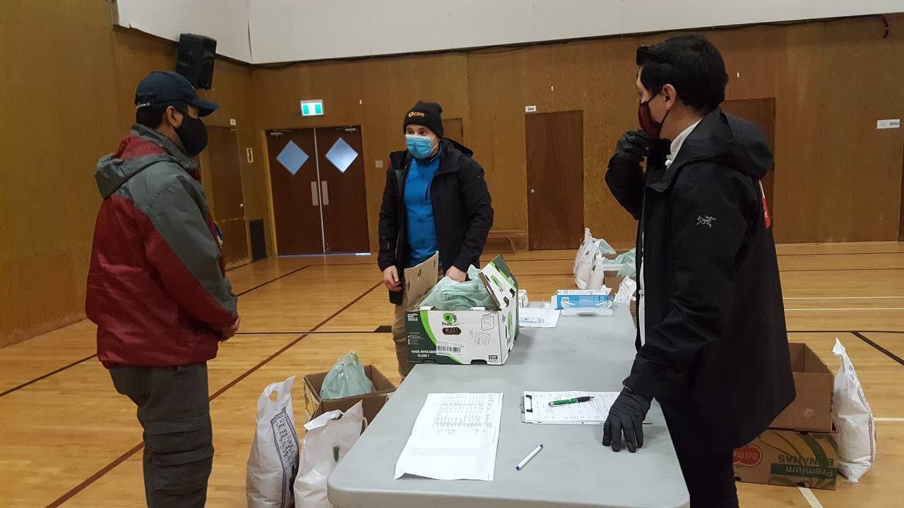 Volunteers organizing food on tables